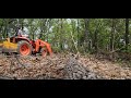 clear some woods with kubota l2501  dt and pallet forks. uprooting small trees