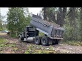 Efficient Gravel Delivery: 12 cu. yards Unloaded Evenly by Dump Truck for Campground Road.