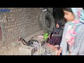 Farida Khanom and grandmother cooking some kind of local bread