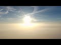 Drone rising above See of Clouds - an Artificial Sunrise
