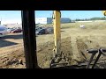 CAT 320 loading clay on rock trucks - cab view