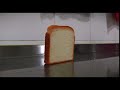 Piece of bread falling over, but it again stands up