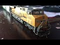 My Intermountain HO Scale Union Pacific GE ES44AC 5367 with a couple of HO scale Grain Hopper cars