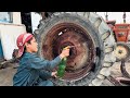 An expert mechanic repairs a rusty tractor that has been left in the rain for years