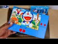 Box full of doraemon stationery - piggybank, calculator pencil box, projector watch, pencil sharpner