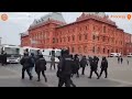 Russian police detaining woman holding card/sign that says 