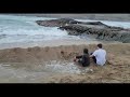 Ocean smashes kids dam built to stop the tide