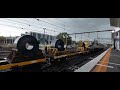 Storm approaches as a freight train trundles through Frankston Station & meets a Metro train.