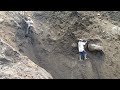 dropping stones on black sand cliffs