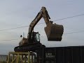 Cat 319D LN climbing onto rail car