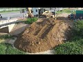 Fresh Initiative! dump truck with soil bulldozers shut down the water dam by push soil into water.