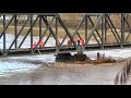 BNSF Railroad uses locomotives to clear log jam from bridge Puyallup, WA