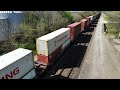 Drone views of a colorful container train led by SD70ACe BNSF #9259 through Henrietta MO