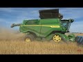 JOHN DEEERE X9 1100 Combine on Tracks Harvesting Wheat