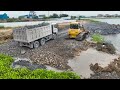 whole project Big Lake being filled with stone! Bulldozer pushing stone, delivering by truck stone