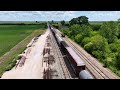 Dash 9 and ES44DC in BNSF H2 paint schemes lead some brand new CN boxcars through midwest cornfields