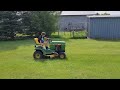 The boys mowing lawn with the John Deere 425 and 111.