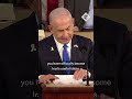 Democrat representative holds 'war criminal' sign at Netanyahu address