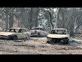 Devastation and smoke rise from the ashes of California wildfires