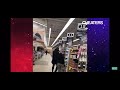 Woman get caught trying to pass her number off behind her boyfriends back to a guy in the store