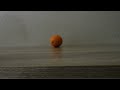 Watch an Orange Disappear over a Flat Table using a Lens