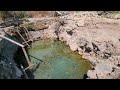 Unblocking a natural spring providing water to an island neighborhood