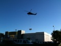 5 State Helicopter Replacing large HVAC units on roof of a commercial building.