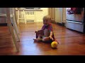 Cute baby laughs at bouncing ball