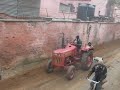 Driving a tractor in India and making it move dirt and tear up asphalt