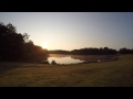 Fog moving over lake water at sunrise (Time Lapse)